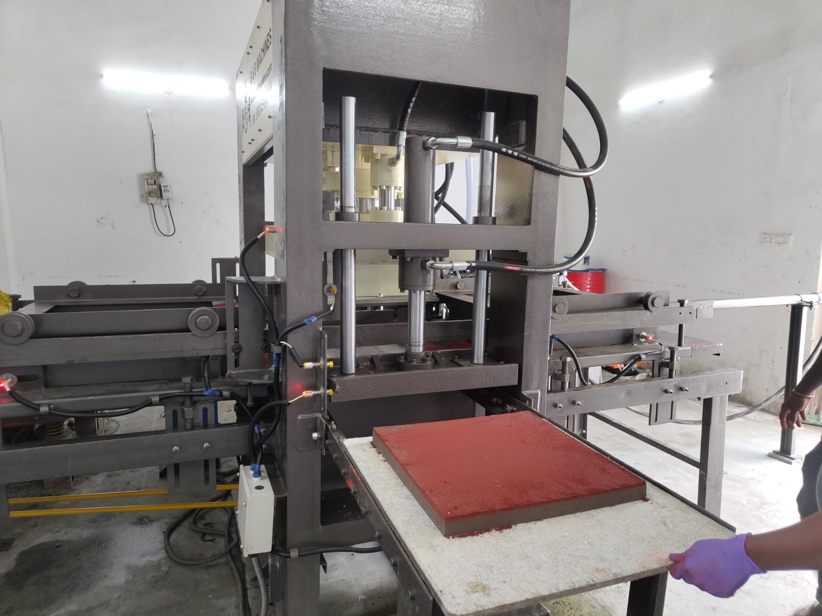 Bilayered building product manufacturing unit